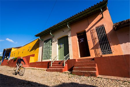 Man on Bicycle Riding Past Colorful Houses, Trinidad, Cuba Stock Photo - Rights-Managed, Code: 700-06465969