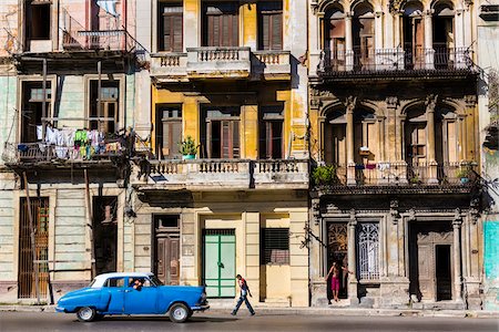 simsearch:700-06465934,k - Blue Classic Car Driving Past Residential Apartment Buildings, Havana, Cuba Stock Photo - Rights-Managed, Code: 700-06486571