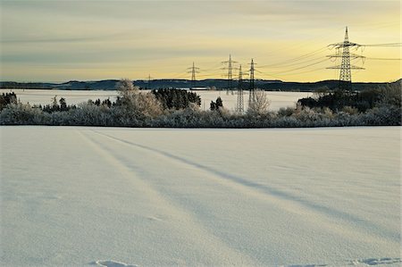 simsearch:600-08519367,k - Snow Coverd Faded Tire Tracks and Hydro Power Line in Field in Winter at Dawn, near Villingen-Schwenningen, Schwarzwald-Baar, Baden-Wuerttemberg, Germany Stock Photo - Rights-Managed, Code: 700-06505783