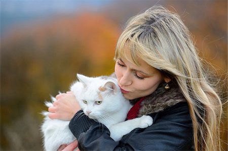 Woman with Blond Hair Kissing Cat Outdoors Stock Photo - Rights-Managed, Code: 700-06531484