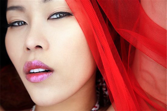 Close up of face of young woman wearing red scarf, looking at camera, Bangkok, Thailand Stock Photo - Premium Rights-Managed, Artist: dk & dennie cody, Image code: 700-06531688