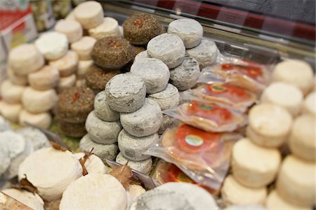 food photography close up - Fresh wedges and rounds of French goat cheese in artisan cheese shop, La Fromagerie, Paris, France Stock Photo - Rights-Managed, Code: 700-06531954