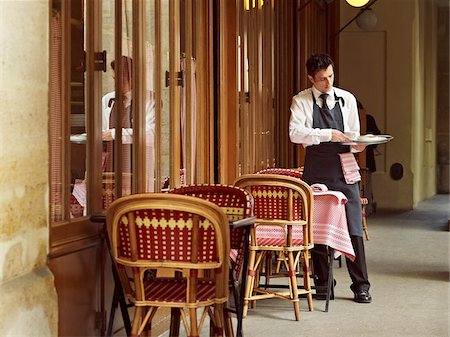 waiter clearing dishes at charming outdoor cafe, Fontaine de Mars, Paris, France Photographie de stock - Rights-Managed, Code: 700-06531968