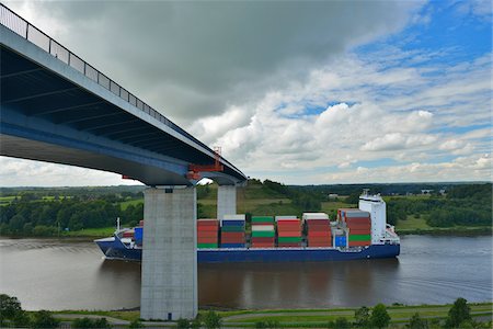 engineering - Ship Passing Under Bridge over Kiel Canal in Summer, Bornholt, Schleswig-Holstein, Germany. The Kiel Canal links the North Sea to the Baltic Sea. Stock Photo - Rights-Managed, Code: 700-06571084