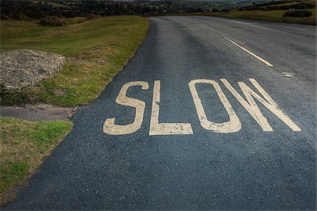 european roads not people not lifestyle not illustration - "Slow" road marking on hill, Dartmoor, Devon, UK Foto de stock - Con derechos protegidos, Código: 700-06571133