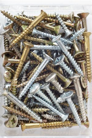 close-up of assortment of gold and silver metal screws Fotografie stock - Rights-Managed, Codice: 700-06701950