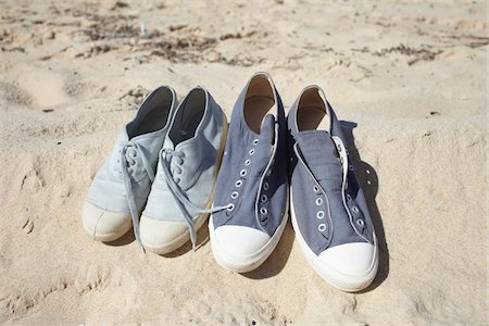 seines und ihres - Two pairs of blue sneaker shoes on sand at the beach Stockbilder - Lizenzpflichtiges, Bildnummer: 700-06714055