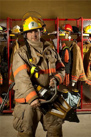 protective clothing - Fire Figher holding Hydraulic Rescue Tool in Fire Station, Ontario Stock Photo - Rights-Managed, Code: 700-06758374