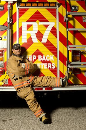 firefighter not pretend - Fire Fighter Sitting on Back of Fire Truck, Ontario Stock Photo - Rights-Managed, Code: 700-06758378