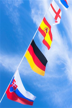 Slovakian, German, Spanish, English, and Dutch flags against blue summer sky Photographie de stock - Rights-Managed, Code: 700-06752258