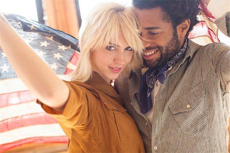 smile mixed race couple - Couple wrapped in an American flag, Portland Oregon USA Stock Photo - Rights-Managed, Code: 700-06786688