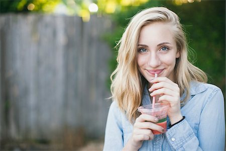 simsearch:700-06786697,k - Blonde teenage girl drinking a smoothie in backyard Stock Photo - Rights-Managed, Code: 700-06786698