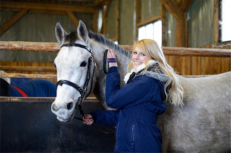 Young Woman grooms a Half Arabian Quarterhorse in his stable, Bavaria, Germany Stock Photo - Rights-Managed, Code: 700-06786882
