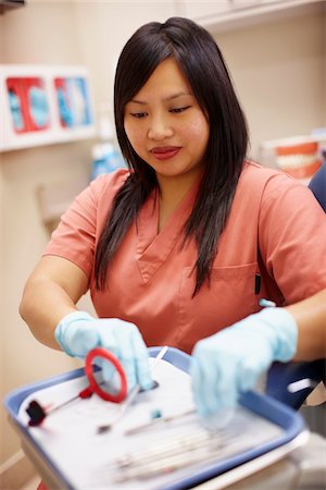 simsearch:700-05389250,k - Female dental hygienist laying out tools on tray. Stock Photo - Rights-Managed, Code: 700-06786920