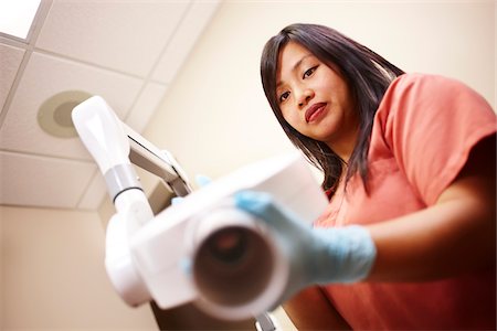 simsearch:700-05389250,k - Female dental hygienist operating x-ray machine. Stock Photo - Rights-Managed, Code: 700-06786921