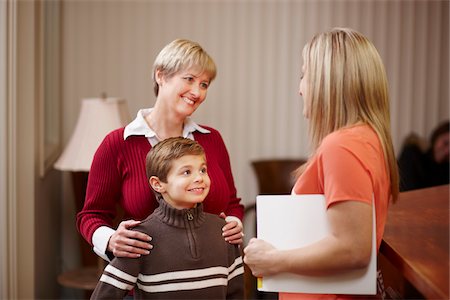 Young boy with mother being greeted by dental hygienist at dentist office Stock Photo - Rights-Managed, Code: 700-06786949