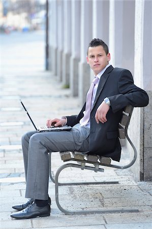 full body people sitting laptop - Young Businessman with Laptop Sitting on Bench, Bavaria, Germany Stock Photo - Rights-Managed, Code: 700-06786957