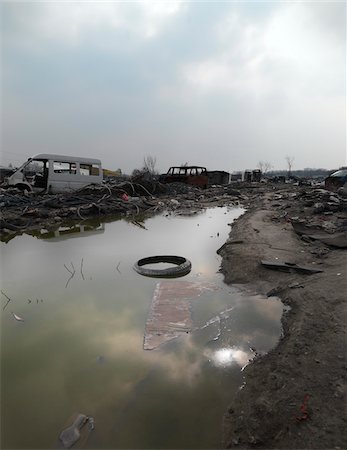 Tire floating in puddle in burnt out wasteland, Saint Denis, France Stock Photo - Rights-Managed, Code: 700-06808740