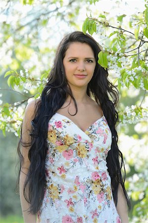 Portrait of a young woman standing beside a flowering cherry tree in spring, Germany Stock Photo - Rights-Managed, Code: 700-06808862