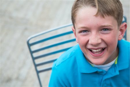 Boy with freckles looking up and laughing. Stock Photo - Rights-Managed, Code: 700-06808953