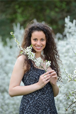 simsearch:700-05389250,k - Close-up of a young woman holding a flowering blackthorn branch in her hands in spring, Germany Stock Photo - Rights-Managed, Code: 700-06841658