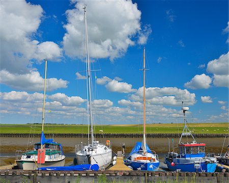 Boats in the Mud Flat Harbor in Summer, Tuemlauer-Koog, Schleswig-Holstein, Germany Stock Photo - Rights-Managed, Code: 700-06899719