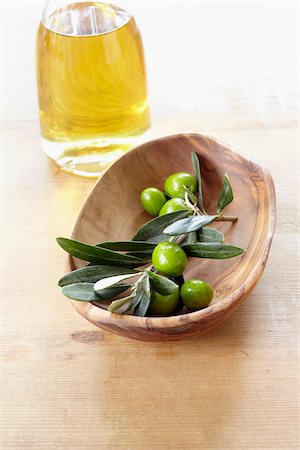 sprig - close-up of small wooden bowl with olive twig, fresh olives and bottle of olive oil Stock Photo - Rights-Managed, Code: 700-06899801