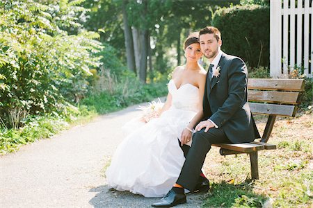 sitting on park bench - Portrait of Bride and Groom sitting on wooden bench outdoors, looking at camera, Ontario, Canada Stock Photo - Rights-Managed, Code: 700-06939701