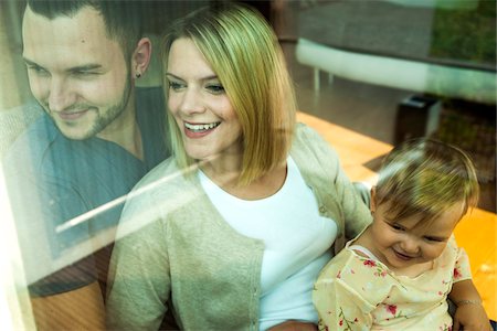 family relaxing living room - Family by Window at Home, Mannheim, Baden-Wurttemberg, Germany Stock Photo - Rights-Managed, Code: 700-06962028