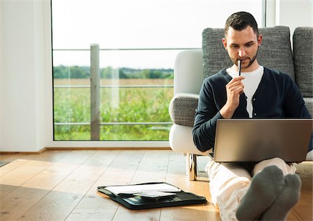 sitting on floor - Young Man using Laptop Computer at Home, Mannheim, Baden-Wurttemberg, Germany Stock Photo - Rights-Managed, Code: 700-06962036