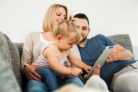 european family home - Family using Tablet Computer in Living Room at Home, Mannheim, Baden-Wurttemberg, Germany Stock Photo - Rights-Managed, Code: 700-06962055