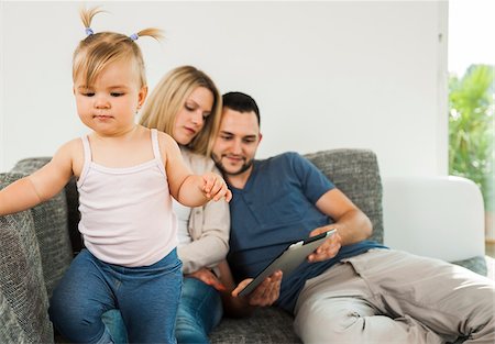 family leave - Family using Tablet Computer in Living Room at Home, Mannheim, Baden-Wurttemberg, Germany Stock Photo - Rights-Managed, Code: 700-06962056