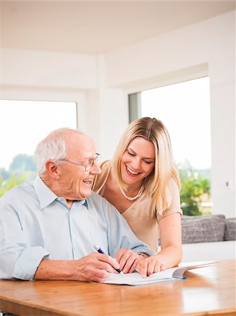 document - Young Woman and Senior Man looking at Document, Mannheim, Baden-Wurttemberg, Germany Stock Photo - Rights-Managed, Code: 700-06962187