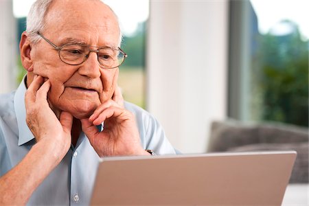 Senior Man using Laptop at Home, Mannheim, Baden-Wurttemberg, Germany Stock Photo - Rights-Managed, Code: 700-06962182