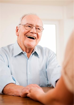 Senior Man Smiling and Talking to Young Woman at Home, Mannheim, Baden-Wurttemberg, Germany Foto de stock - Con derechos protegidos, Código: 700-06962192