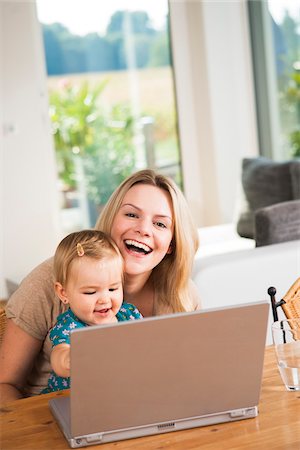 Young Woman and Baby Girl using Computer, Mannheim, Baden-Wurttemberg, Germany Stock Photo - Rights-Managed, Code: 700-06962193