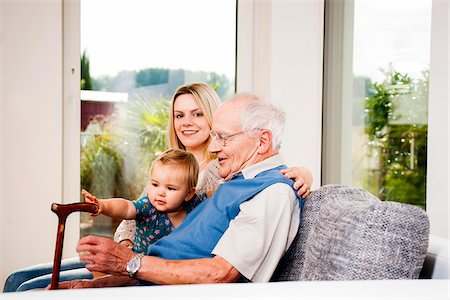 simsearch:600-06892776,k - Young Woman with Baby Girl and Senior Man on Sofa, Mannheim, Baden-Wurttemberg, Germany Stock Photo - Rights-Managed, Code: 700-06962206