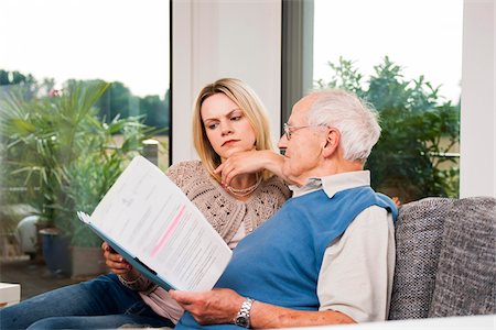 Young Woman and Senior Man looking at Document, Mannheim, Baden-Wurttemberg, Germany Foto de stock - Con derechos protegidos, Código: 700-06962200