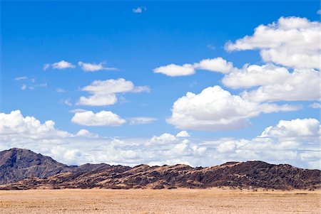puffy clouds - Namib Desert with Mountains in Distance, Namibia, Africa Stock Photo - Rights-Managed, Code: 700-06962210