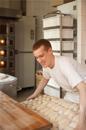 Male baker lifting tray of bread dough lumps in bakery, Le Boulanger des Invalides, Paris, France Photographie de stock - Rights-Managed, Code: 700-07156251