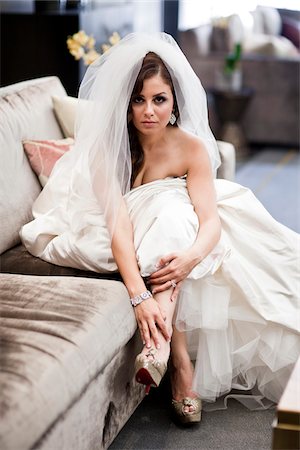Portrait of bride sitting on sofa wearing wedding gown and veil, Ontario, Canada Stock Photo - Rights-Managed, Code: 700-07199831