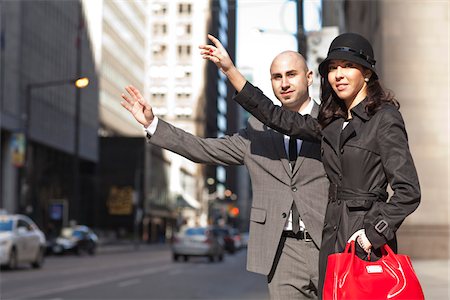 Young, fashionable couple standing on city street, hailing a cab, Toronto, Ontario, Canada Foto de stock - Con derechos protegidos, Código: 700-07237625