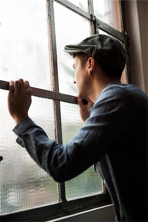 Portrait of Young Man Looking out Window, Mannheim, Baden-Wurttemberg, Germany Photographie de stock - Rights-Managed, Code: 700-07238134