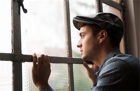 Portrait of Young Man Looking out Window, Mannheim, Baden-Wurttemberg, Germany Stock Photo - Rights-Managed, Code: 700-07238133