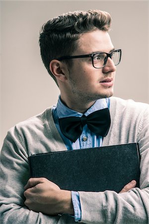 Portrait of Student wearing Bow Tie and Glasses with Binder, Studio Shot Photographie de stock - Rights-Managed, Code: 700-07238145