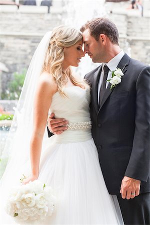 Portrait of Bride and Groom standing face-to-face outdoors with arms around each other on Wedding Day, Canada Photographie de stock - Rights-Managed, Code: 700-07232330