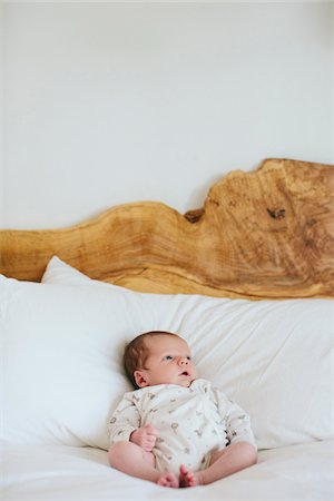 simsearch:700-03556761,k - Baby boy laying on a modern, wooden bed, looking upward, USA Photographie de stock - Rights-Managed, Code: 700-07240910