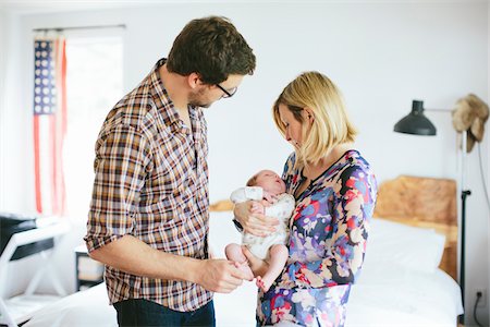 parent - Mom holding newborn, baby boy with Dad standing next to them in bedroom, USA Stock Photo - Rights-Managed, Code: 700-07240911