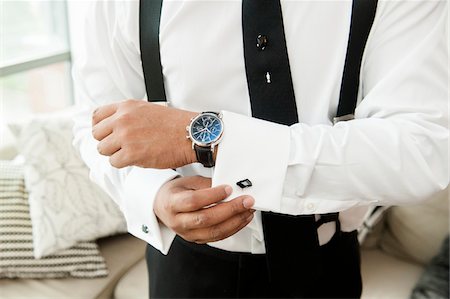 suspenders (straps worn over shoulders) - Close-up of Groom putting on Cuff Links for Wedding Stock Photo - Rights-Managed, Code: 700-07363844