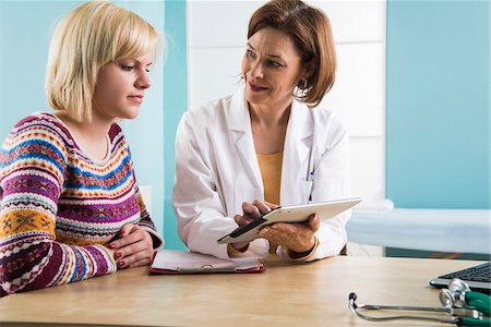 female doctor and patient - Mature Doctor with Patient in Doctor's Office Stock Photo - Rights-Managed, Code: 700-07453666